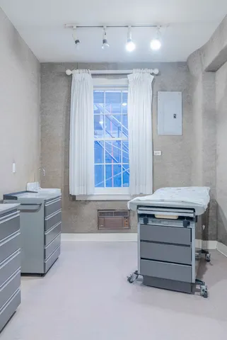 a view of a workspace with furniture and wooden floor