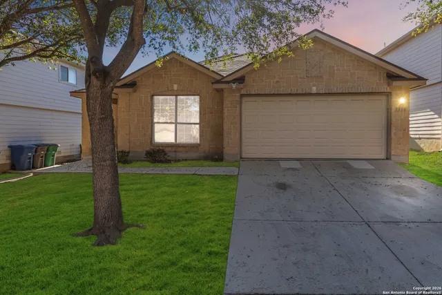 a front view of a house with a yard and garage