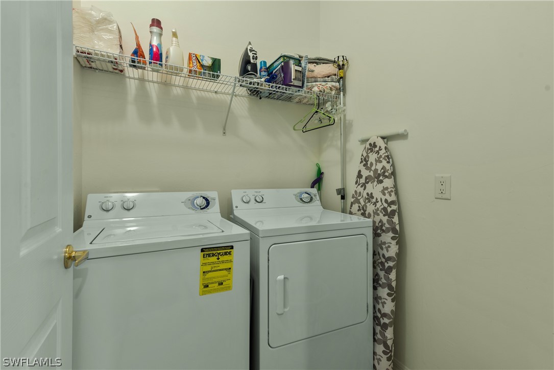 10013 Sky View Way, Unit 1705 Fort Myers, FL 33913 - Photo 14 of 24 a utility room with dryer and washer