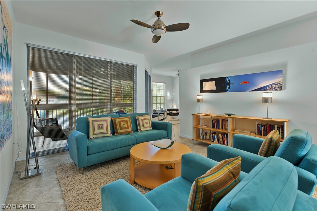 10013 Sky View Way, Unit 1705 Fort Myers, FL 33913 - Photo 2 of 24 a living room with furniture ceiling fan and a rug