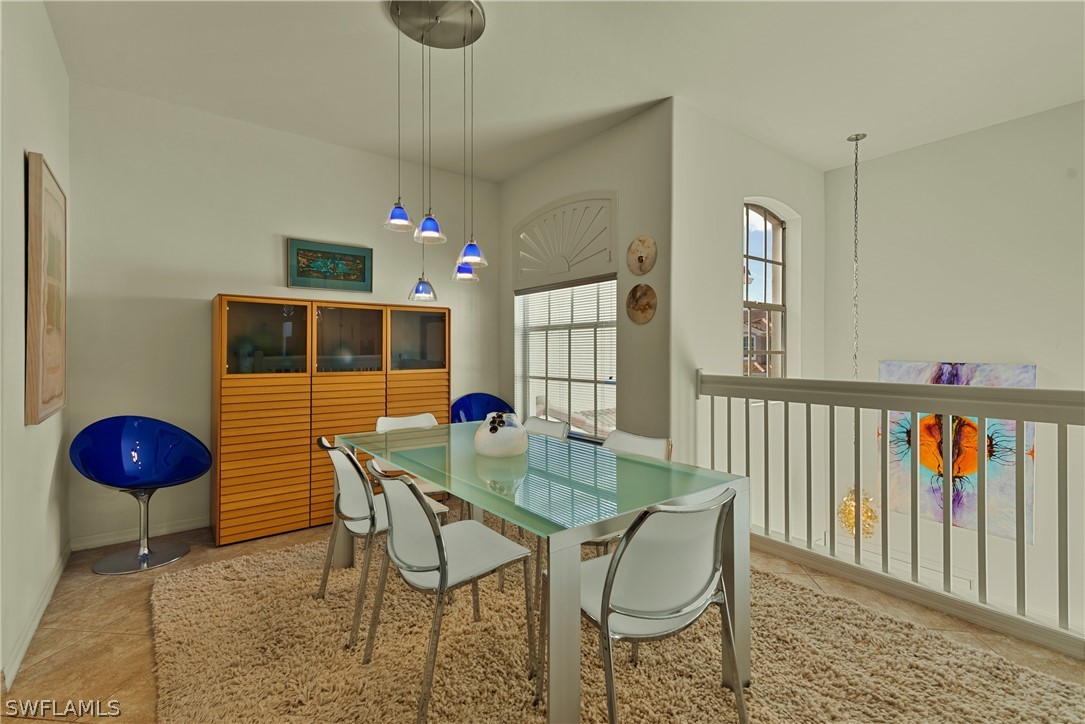 10013 Sky View Way, Unit 1705 Fort Myers, FL 33913 - Photo 5 of 24 a dining room with furniture and wooden floor