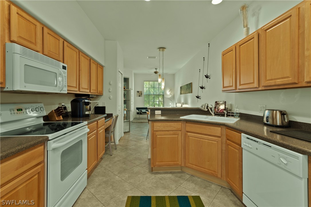 10013 Sky View Way, Unit 1705 Fort Myers, FL 33913 - Photo 6 of 24 a kitchen with stainless steel appliances granite countertop a sink stove and cabinets