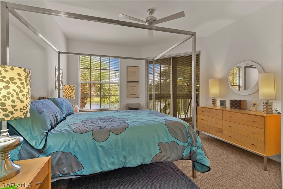 10013 Sky View Way, Unit 1705 Fort Myers, FL 33913 - Photo 9 of 24 a bedroom with a bed mirror and window
