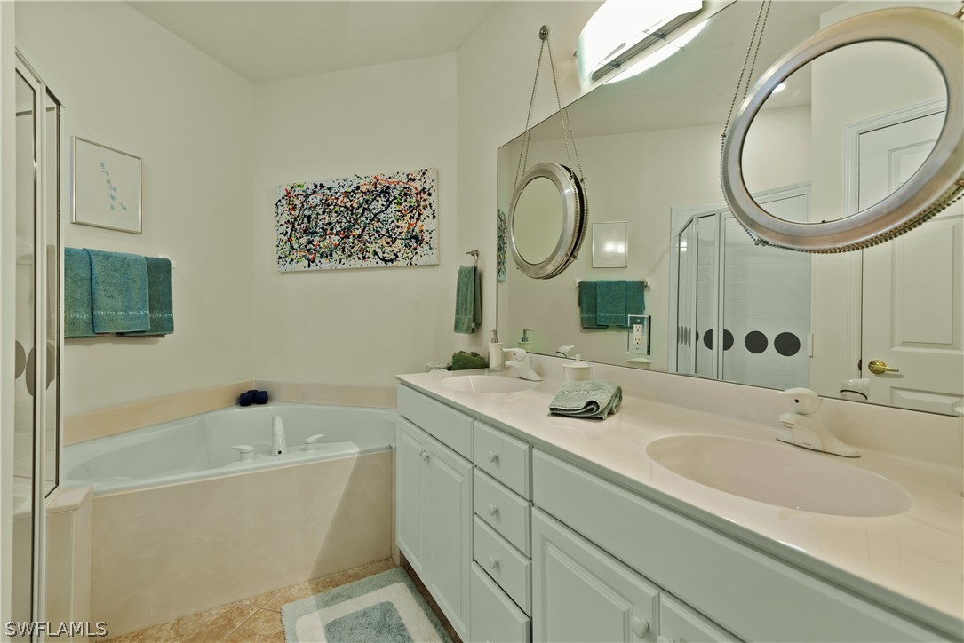 10013 Sky View Way, Unit 1705 Fort Myers, FL 33913 - Photo 10 of 24 a bathroom with a sink and a mirror