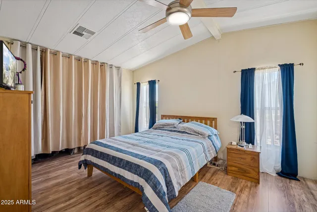 a bedroom with a bed and a mirror