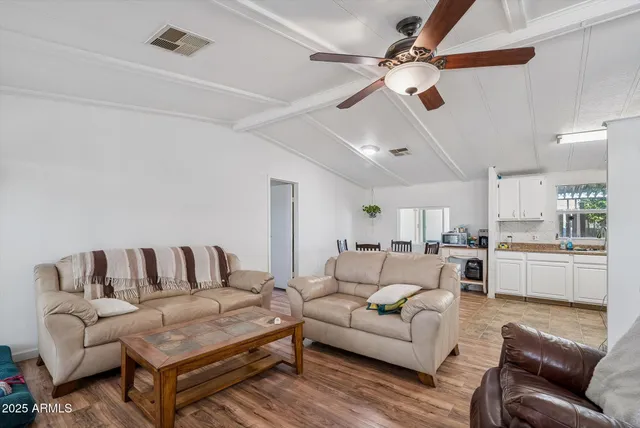 a living room with furniture a ceiling fan and a rug
