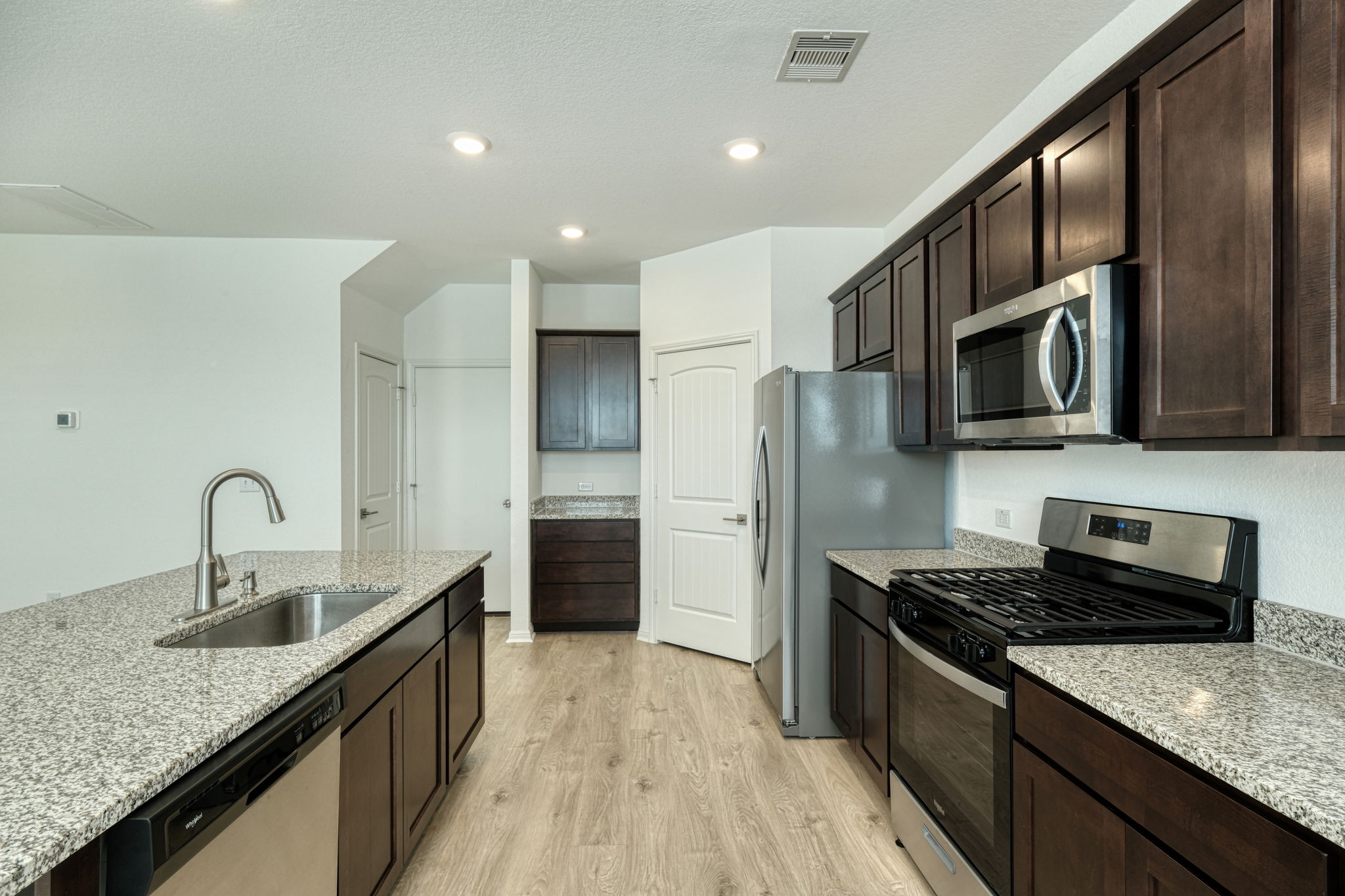 409 Brody Lane Georgetown, TX 78626 - Photo 4 of 14 a kitchen with stainless steel appliances granite countertop a sink stove and refrigerator