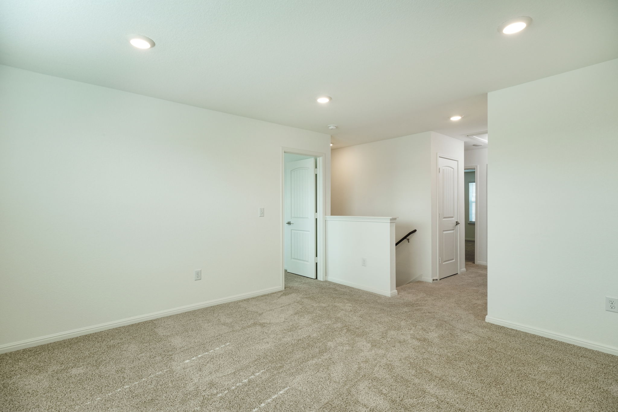 409 Brody Lane Georgetown, TX 78626 - Photo 5 of 14 wooden floor in an empty room with a kitchen