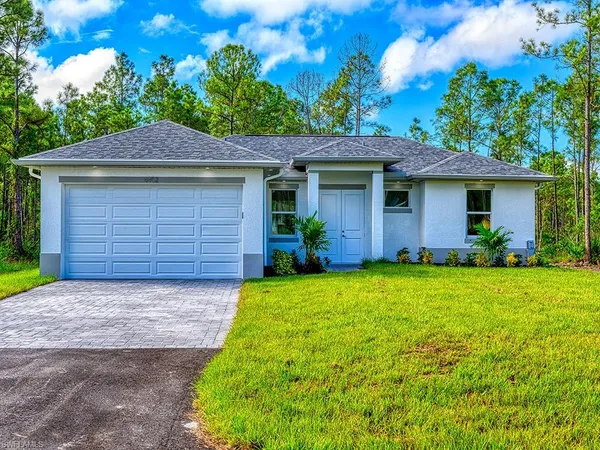 a front view of house with yard and trees