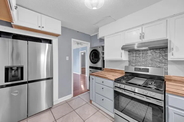 a kitchen with stainless steel appliances granite countertop a stove and a refrigerator