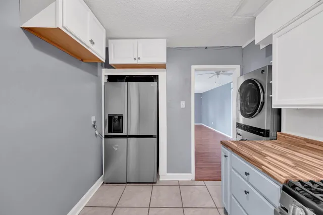 a kitchen with a refrigerator and cabinets