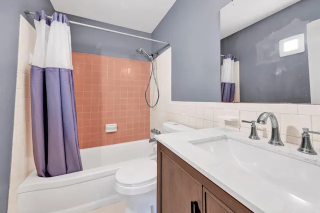 a bathroom with a sink a toilet and a shower