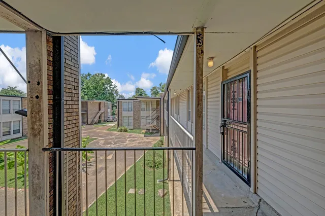 a view of balcony with wooden floor