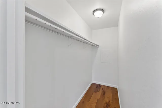 a view of a room with wooden floor