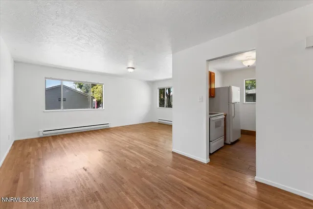 a view of a kitchen with wooden floor and electronic appliances