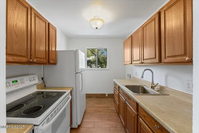 a kitchen with a sink a stove and cabinets