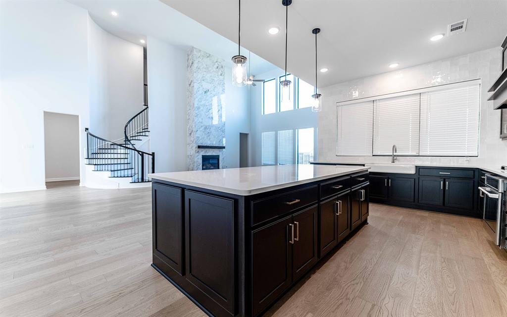 1916 Casting Ridge Mesquite, TX 75181 - Photo 11 of 26 a kitchen with stainless steel appliances granite countertop a sink a stove and a wooden floors