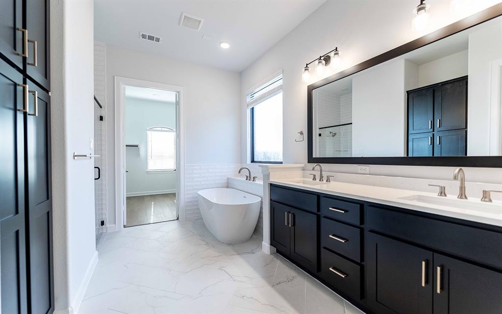 1916 Casting Ridge Mesquite, TX 75181 - Photo 13 of 26 a spacious bathroom with a double vanity sink mirror and double