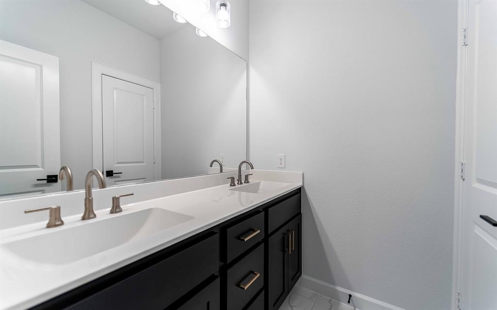 1916 Casting Ridge Mesquite, TX 75181 - Photo 18 of 26 a bathroom with a sink and a mirror