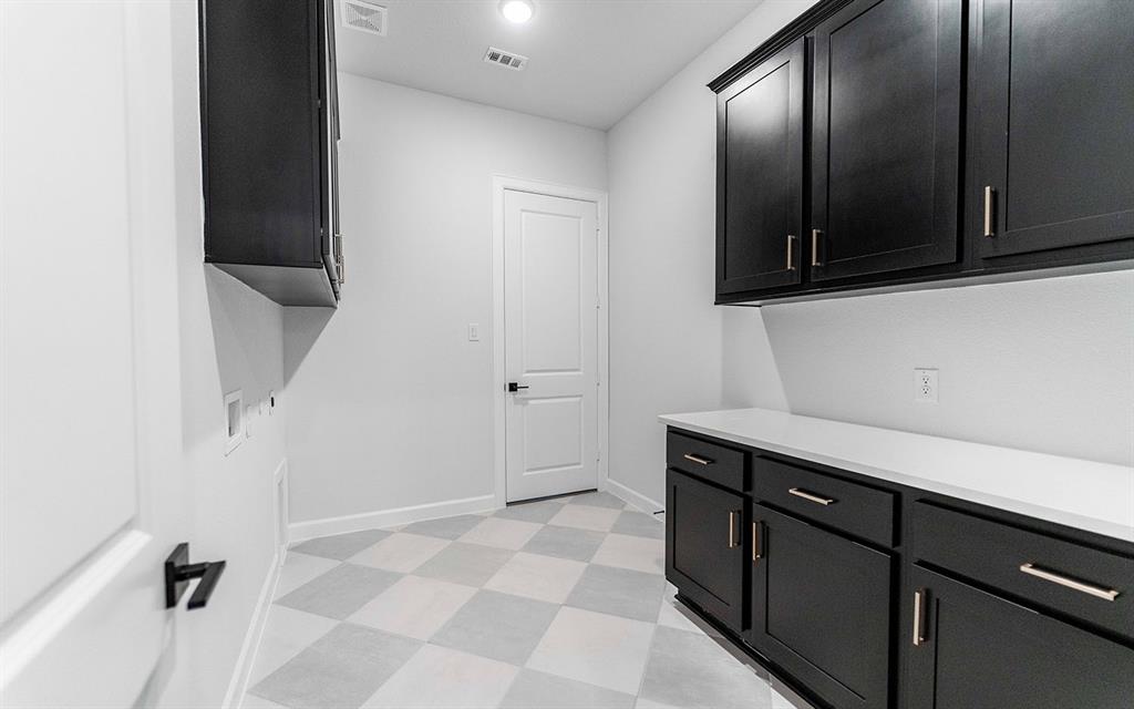 1916 Casting Ridge Mesquite, TX 75181 - Photo 23 of 26 a view of a utility room with cabinets