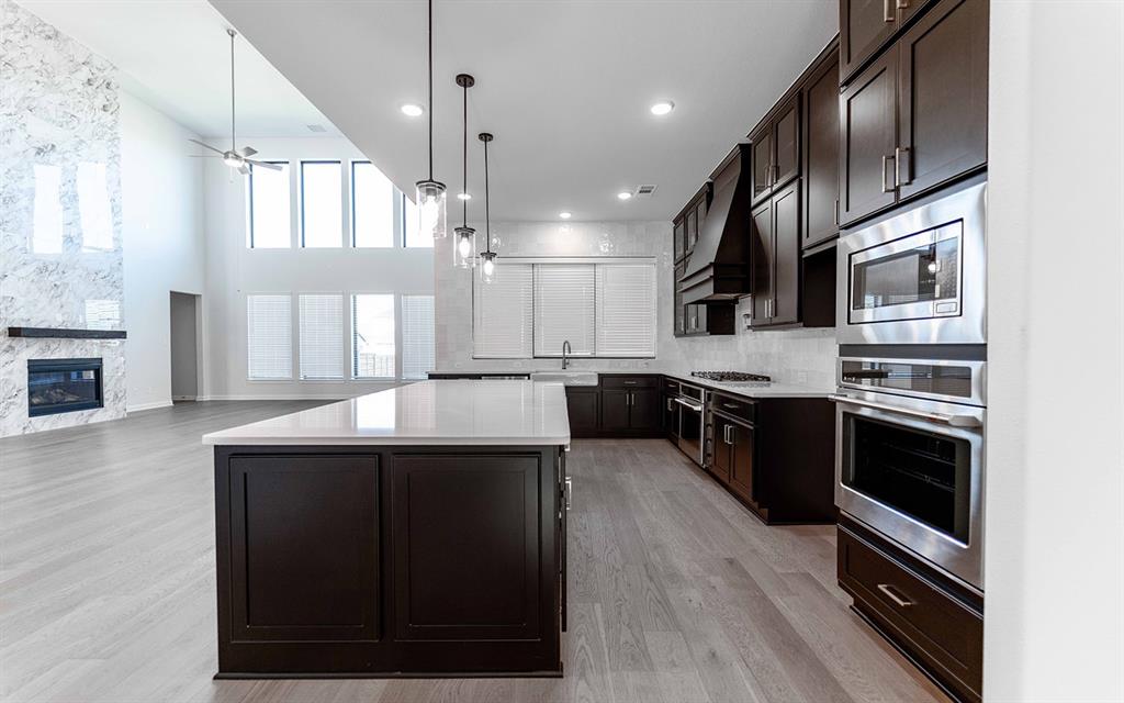 1916 Casting Ridge Mesquite, TX 75181 - Photo 9 of 26 a kitchen with stainless steel appliances kitchen island granite countertop a stove a sink and a microwave