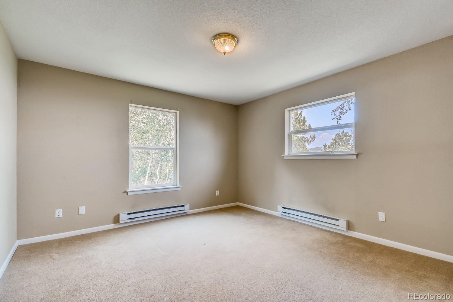 541 Paiute Road Evergreen, CO 80439 - Photo 13 of 22 an empty room with windows