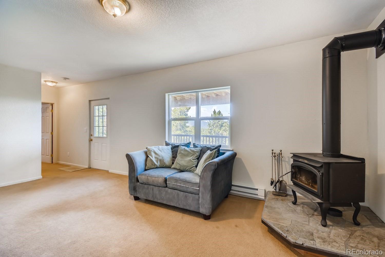 541 Paiute Road Evergreen, CO 80439 - Photo 18 of 22 a living room with furniture and a window