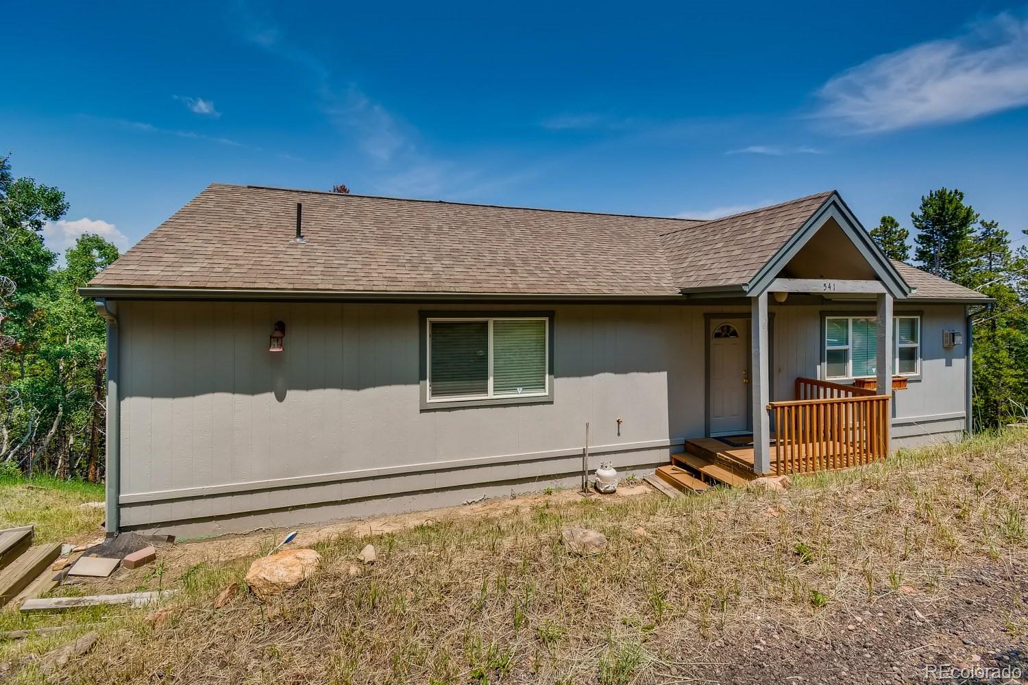 541 Paiute Road Evergreen, CO 80439 - Photo 2 of 22 a front view of a house with garden