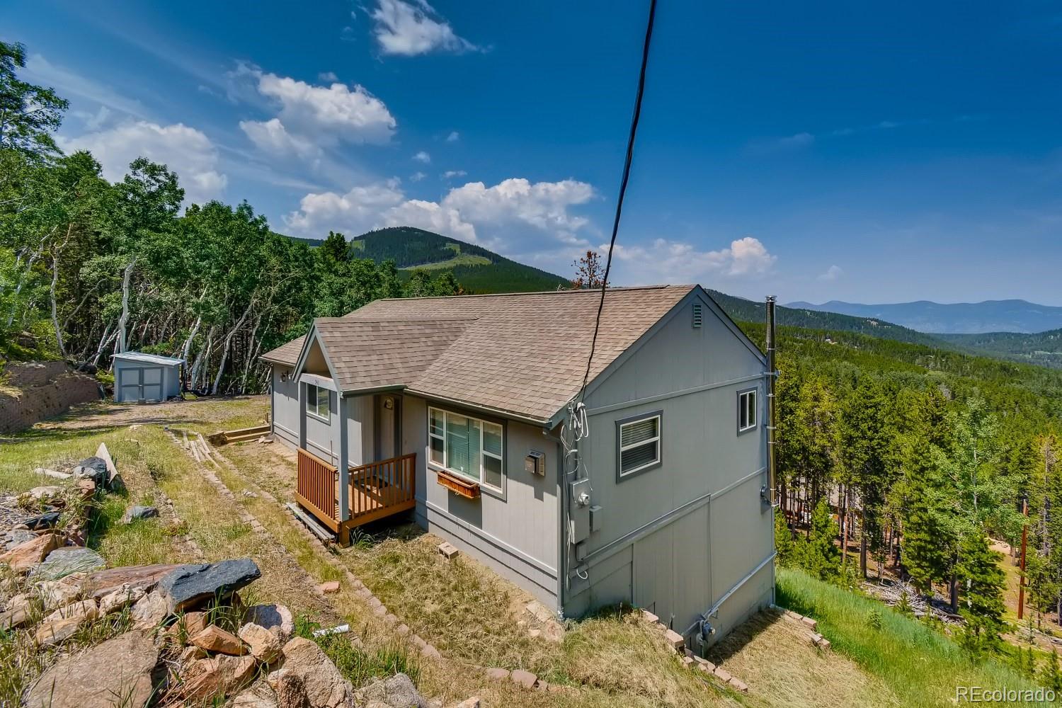 541 Paiute Road Evergreen, CO 80439 - Photo 3 of 22 a view of a house with a yard