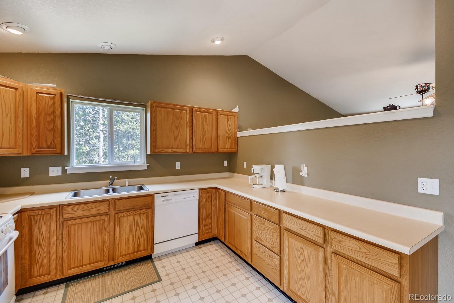 541 Paiute Road Evergreen, CO 80439 - Photo 8 of 22 a kitchen with a sink cabinets and window