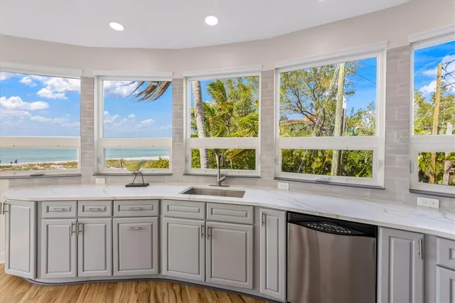 a bedroom with a large bed and a large window with the outer view