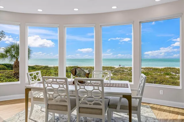 a large kitchen with stainless steel appliances a sink and a large window