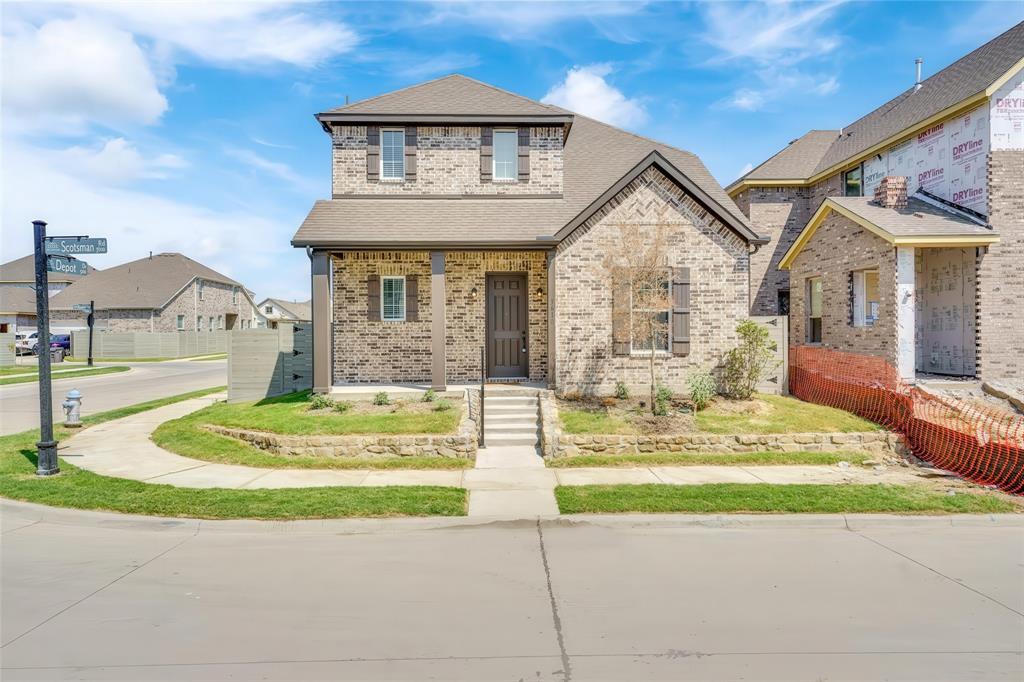3610 Scotsman Road Sachse, TX 75048 - Photo 1 of 34 Brick exterior with stone accents, covered front porch, gabled roofline, and front landscaping with a stone retaining wall
