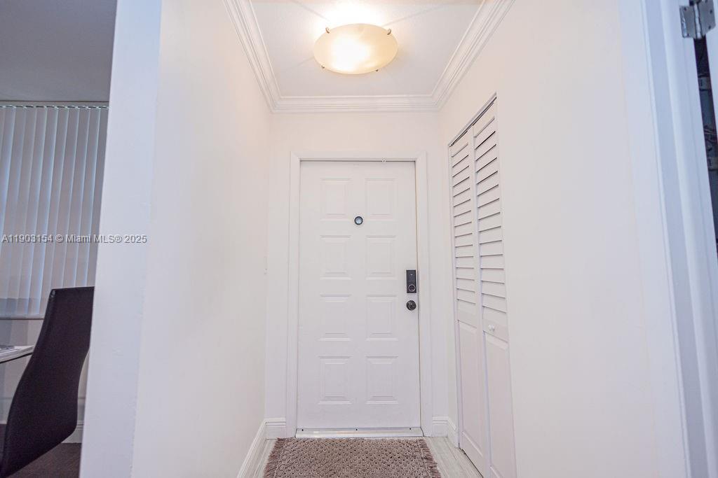 3450 Blue Lake Drive, Unit 305 Pompano Beach, FL 33064 - Photo 11 of 66 a view of a hallway