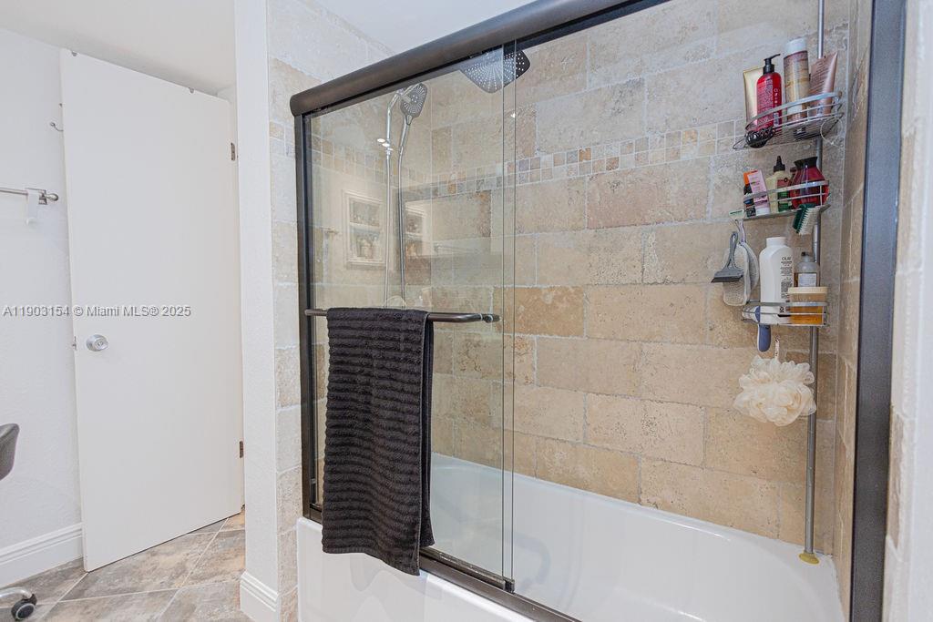 3450 Blue Lake Drive, Unit 305 Pompano Beach, FL 33064 - Photo 13 of 66 a bathroom with a shower