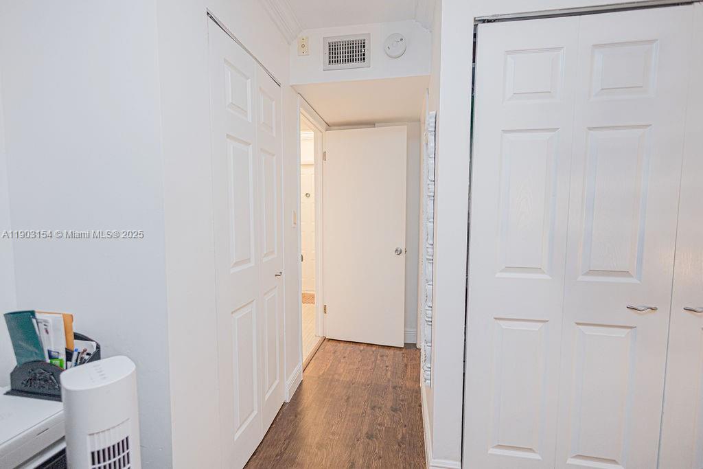 3450 Blue Lake Drive, Unit 305 Pompano Beach, FL 33064 - Photo 14 of 66 a view of a room with wooden floor and closet