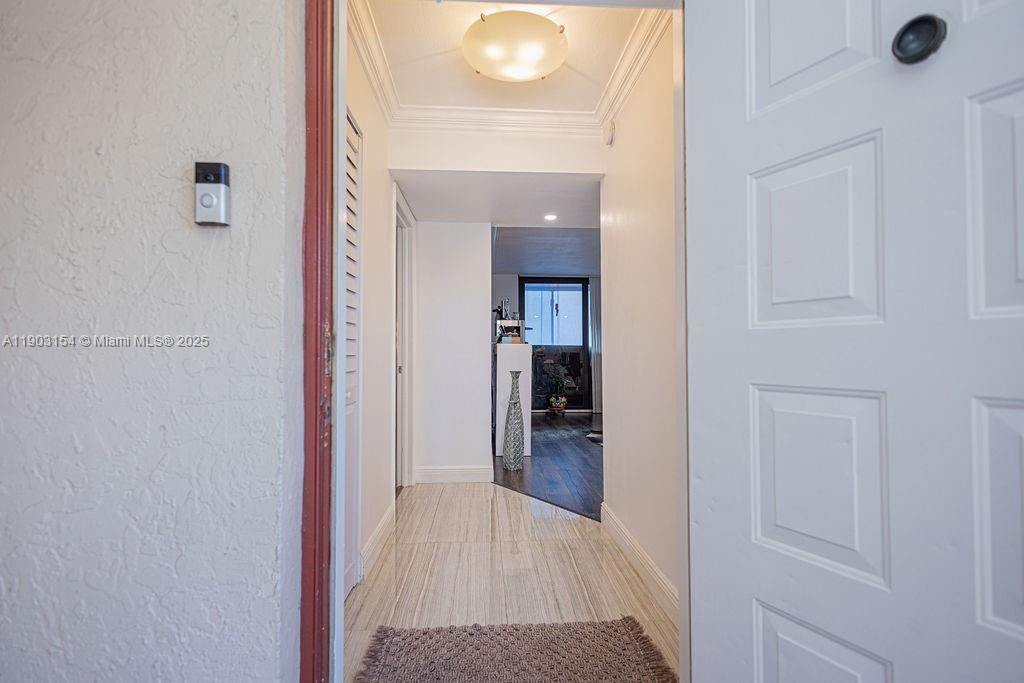 3450 Blue Lake Drive, Unit 305 Pompano Beach, FL 33064 - Photo 20 of 66 a view of a hallway with wooden floor and closet area
