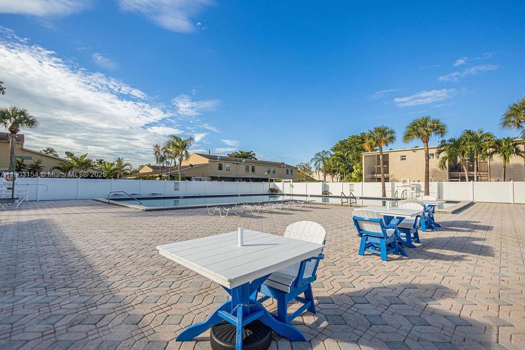 3450 Blue Lake Drive, Unit 305 Pompano Beach, FL 33064 - Photo 25 of 66 a view of a patio with table and chairs