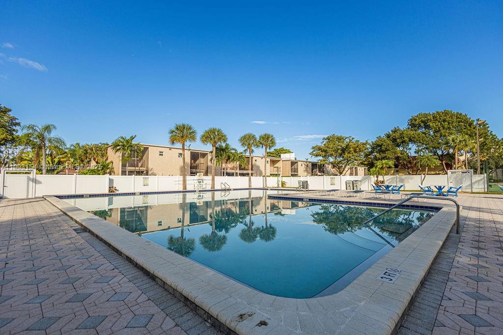 3450 Blue Lake Drive, Unit 305 Pompano Beach, FL 33064 - Photo 28 of 66 a view of a swimming pool with a patio