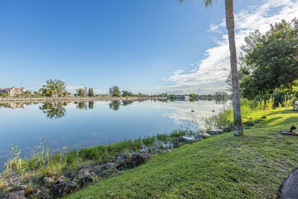 3450 Blue Lake Drive, Unit 305 Pompano Beach, FL 33064 - Photo 36 of 66 a view of a lake with a big yard