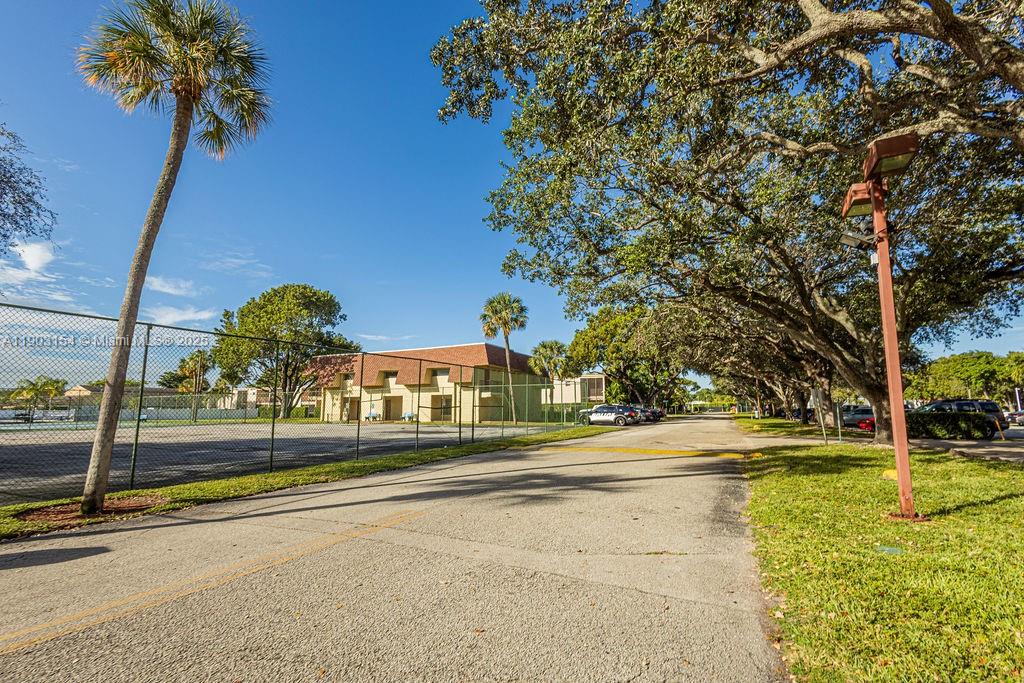 3450 Blue Lake Drive, Unit 305 Pompano Beach, FL 33064 - Photo 37 of 66 a view of a swimming pool with an outdoor space