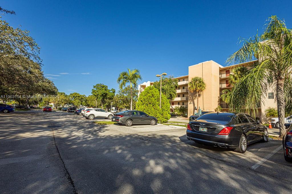 3450 Blue Lake Drive, Unit 305 Pompano Beach, FL 33064 - Photo 38 of 66 a view of a street with cars on road