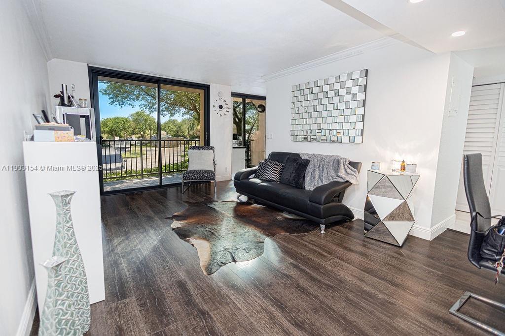 3450 Blue Lake Drive, Unit 305 Pompano Beach, FL 33064 - Photo 42 of 66 a living room with furniture and a floor to ceiling window