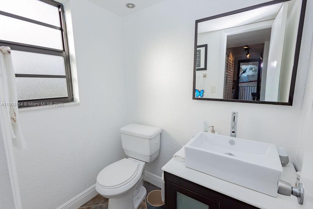 3450 Blue Lake Drive, Unit 305 Pompano Beach, FL 33064 - Photo 48 of 66 a white toilet sitting next to a bathroom sink
