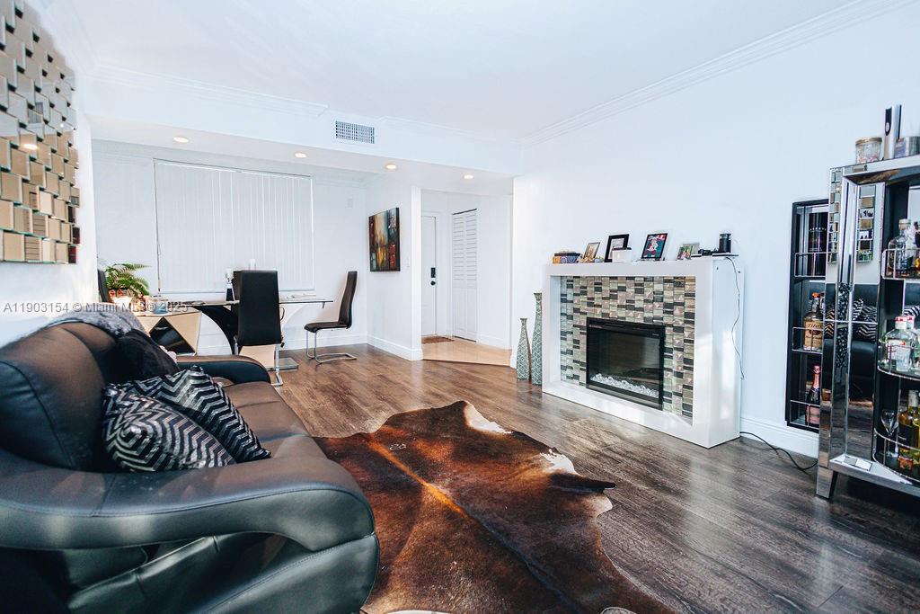 3450 Blue Lake Drive, Unit 305 Pompano Beach, FL 33064 - Photo 49 of 66 a living room with furniture and a fireplace