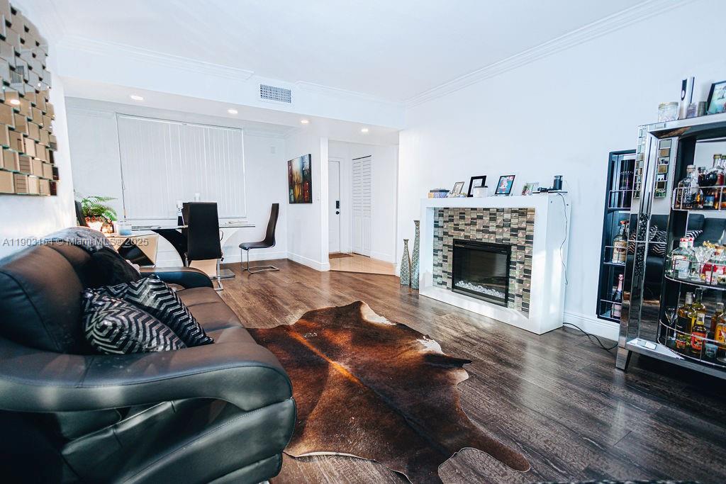 3450 Blue Lake Drive, Unit 305 Pompano Beach, FL 33064 - Photo 50 of 66 a living room with furniture and a fireplace