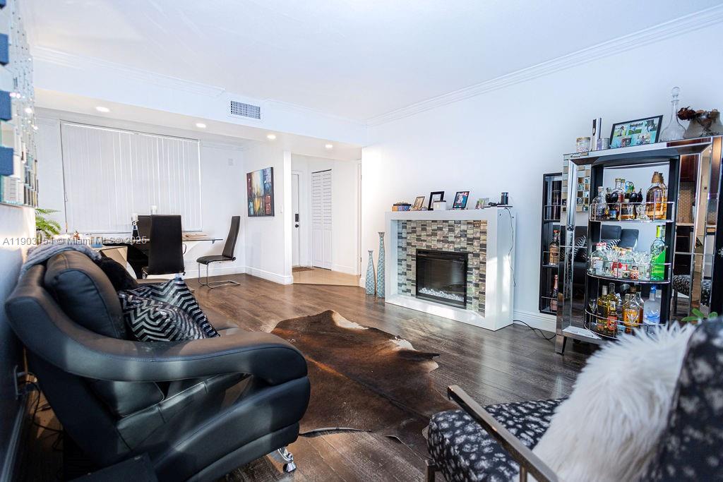 3450 Blue Lake Drive, Unit 305 Pompano Beach, FL 33064 - Photo 51 of 66 a living room with furniture a window and a fireplace