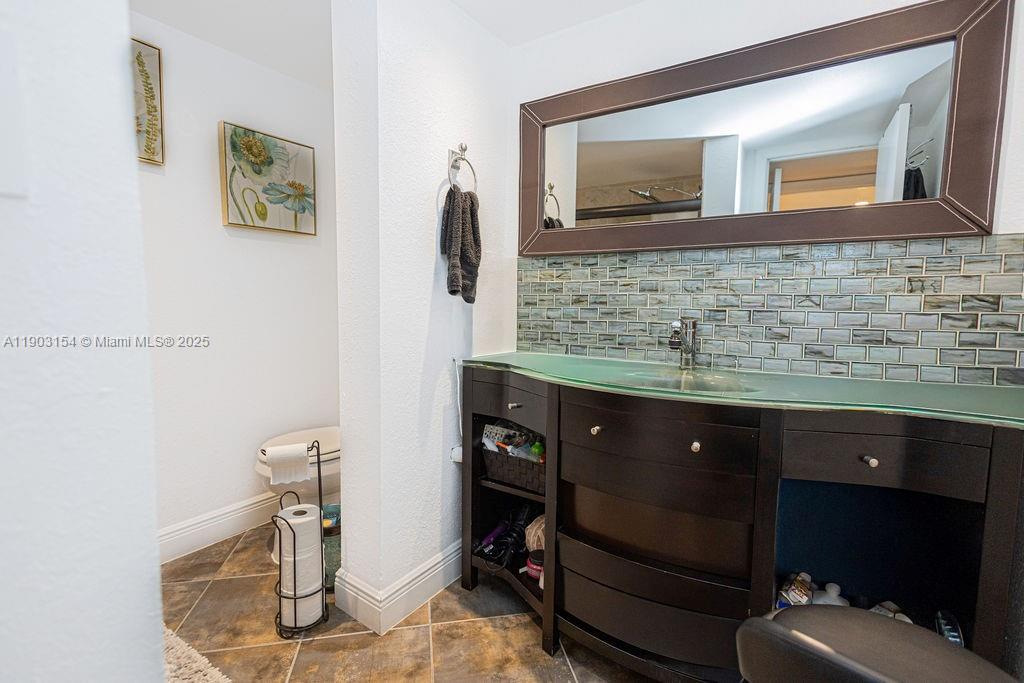 3450 Blue Lake Drive, Unit 305 Pompano Beach, FL 33064 - Photo 53 of 66 a bathroom with a sink and a mirror