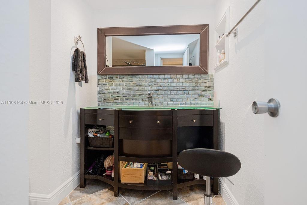 3450 Blue Lake Drive, Unit 305 Pompano Beach, FL 33064 - Photo 54 of 66 a living room with furniture and a mirror