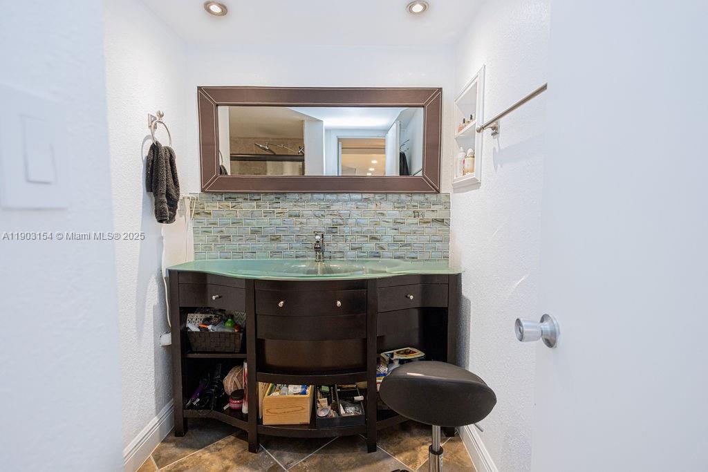 3450 Blue Lake Drive, Unit 305 Pompano Beach, FL 33064 - Photo 55 of 66 a living room with furniture and a mirror